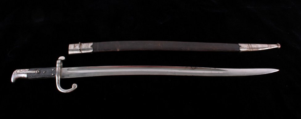 Danish M1867 Rolling Block Bayonet with Scabbard: This is a Danish M1867 rolling block bayonet with scabbard. The bayonet is marked on the ricasso "Gebr. Weyersberg Solingen". The spine of the blade is marked with a crown over "W". The crosspiece is 