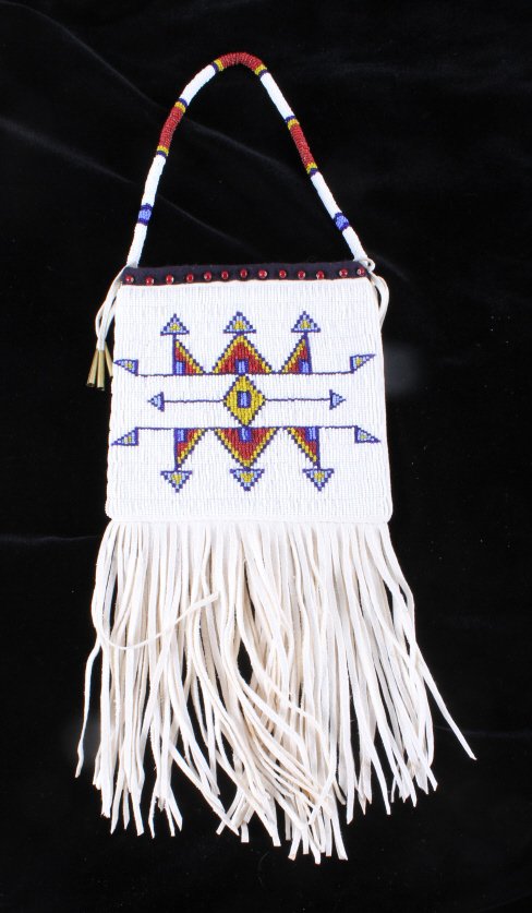 Plains Native American Document Bag: This lot features a Plains Native American document bag. The bag has stunning glass seed beadwork. The bag has whit butterscotch, sky blue, and Hudson Bay red white hearts beads. The bag also has frin