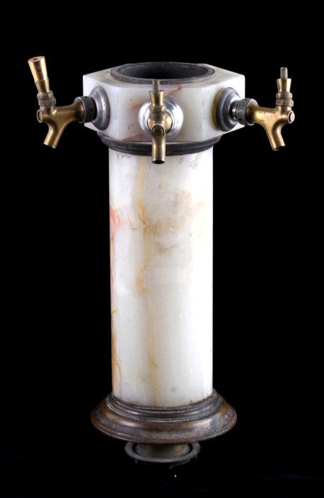 Antique Marble Saloon Beer Tap: This is an antique marble saloon beer tap. The piece features a brass base with a marble column and top. Each tap is made from brass as well. The saloon beer tap is in good overall condition. It measu