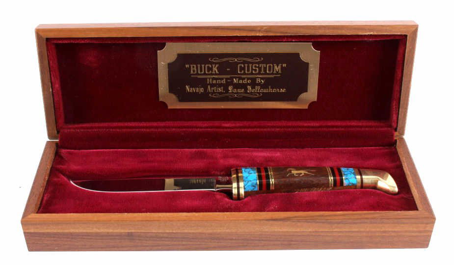 Dave Yellowhorse Navajo Custom Buck Knife: This is a Buck Custom fixed blade knife made by Navajo artist Dave Yellowhorse. This knife shows the running mustang inlaid in brass on each side of the handle. In addition, there is a fantastic mosai