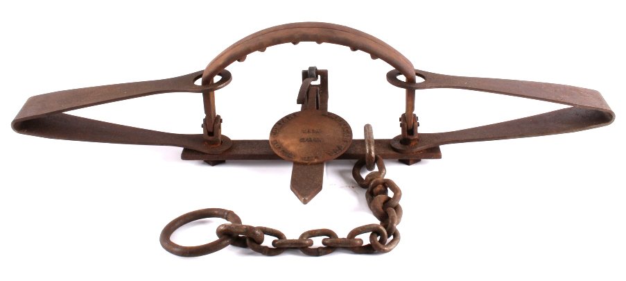 American Fur and Trade Company Grizzly Bear Trap: This is a large grizzly bear trap. The pan is marked "American Fur and Trade Company HBC No. 6". The trap features a double spring composition with a heavy gauge drag chain and ring. The grizzly bear 