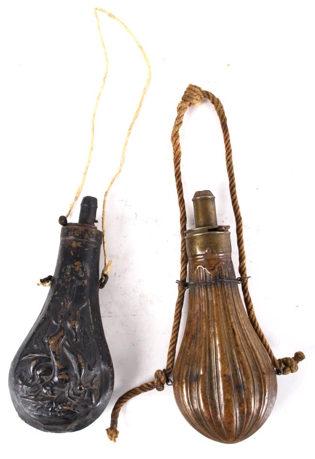 Antique Brass And Copper Gun Powder Flasks: These are antique gun powder flasks. They are made from brass and copper. The flasks are unique in that they have adjustable spouts. One flask shows a beautiful ribbed design and the other has running