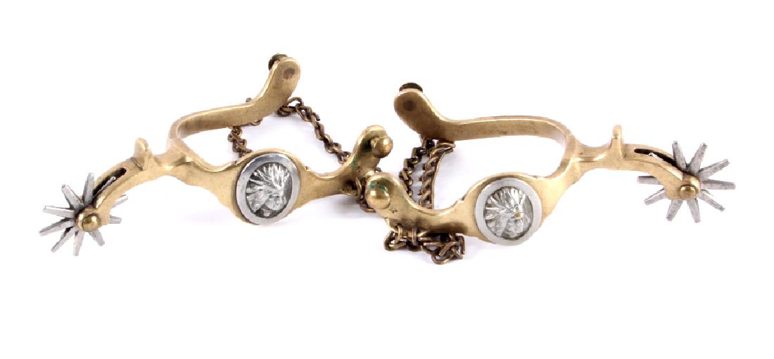 Buermann Hercules Bronze Indian Head Spurs: This is a pair of Buermann Hercules Bronze Indian Head spurs. Each of the spurs is marked with the five point star and "Hercules Bronze" under the stationary strap buttons. The spurs have a drop shank