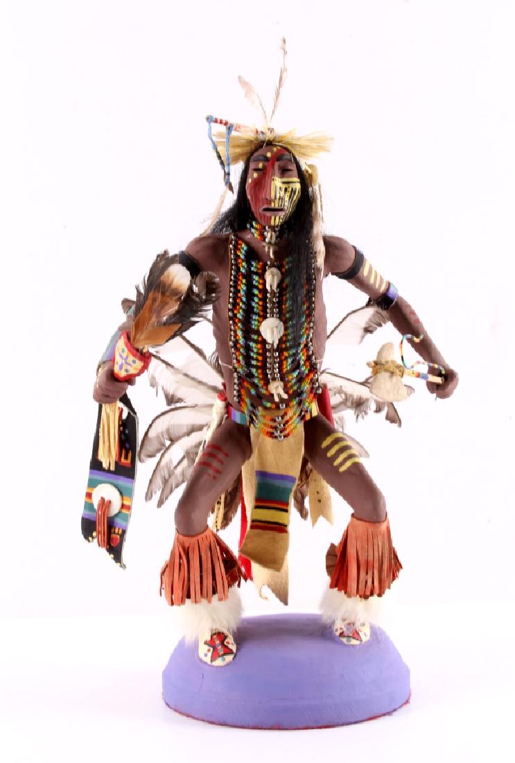 Blackfeet Indian Ceremonial Dance Doll: This is a ceremonial Blackfeet Indian dance doll. The piece has been adorned with beadwork, feathers, fur, etc. In addition, it has been hand painted. The Blackfeet doll is in good condition. It has b