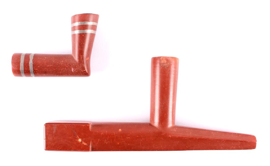 Northern Plains Catlinite Pipe Bowls 1890-1930: The lot features two authentic original catlinite pipestone peace pipe bowls both from the Northern Plains Native American Indians. The first shows a T-shaped bowl with long tapering prow and tall bow