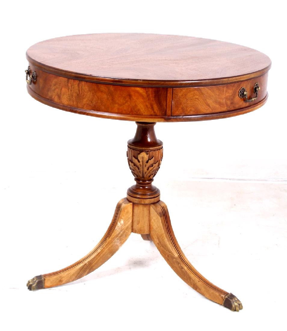 Antique Imperial Duncan Phyfe Drum Table: This is a Duncan Phyfe drum table made by Imperial of Grand Rapids, Michigan. The table features a three leg pedestal with brass claw feet. The center of the pedestal shows a fantastic carved maple le