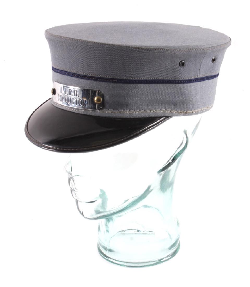 Long Island Railroad Conductor Hat: This is an original conductor hat from the Long Island Railroad. The hat features a badge that is marked "L.I.R.R. Conductor". The hat shows good condition. It is size 7 5/8.