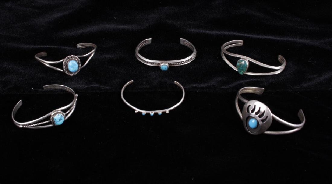 Navajo Turquoise Bracelet Collection: This lot features a collection of Navajo Turquoise bracelets. All of the six bracelets in this collection feature stunning polished turquoise stones and show good craftsmanship. The bear claw bracelet