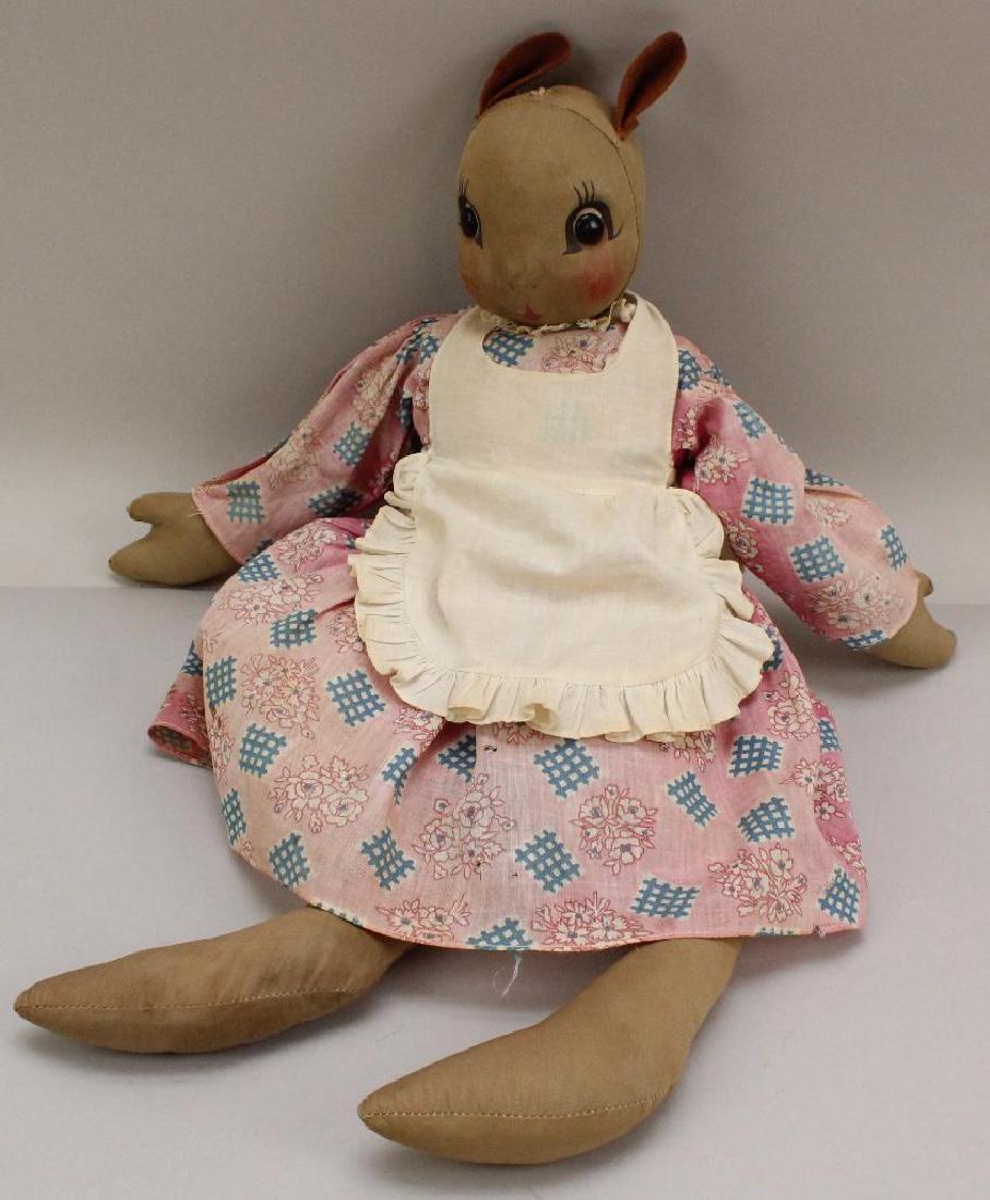 20" ALL ORIGINAL UNMARKED CLOTH GEORGENE "NURSE JANE": Painted features with black shoe button eyes. Felt ears. Original dress, pinafore, pantaloons. Hat is missing. Condition: age fading, discoloration to clothing, body.
