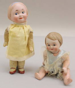 PAIR OF ANTIQUE BISQUE HEAD PAINTED EYE GOOGLY DOLLS.: Both dolls have painted/molded features, blue integlio eyes, blonde hair, 5 pc. papier mache bodies. 6 1/4" Doll is marked NIPPON and has a baby body. Dressed in vintage romper. 7" Doll is marked R/6