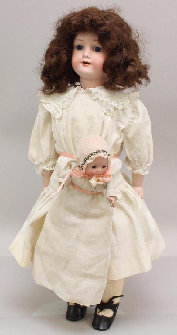 PAIR OF ANTIQUE BISQUE HEAD DOLLS: AM 360 HOLDING HER (1 of 6)