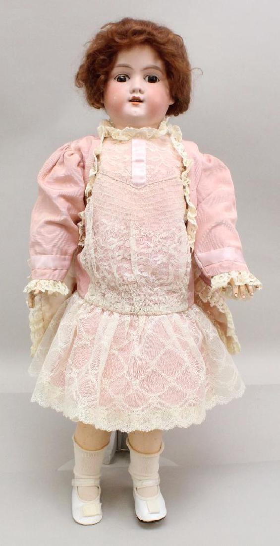 24" MADE IN GERMANY FLORADORA A. 8. M. ANTIQUE BISQUE: Brown sleep eyes, open mouth, red mohair wig. Papier mache ball jointed body. Dressed in pink faille reproduction clothing, newer underwear, shoes, socks Condition: rub on cheek. (1) Finger missing.