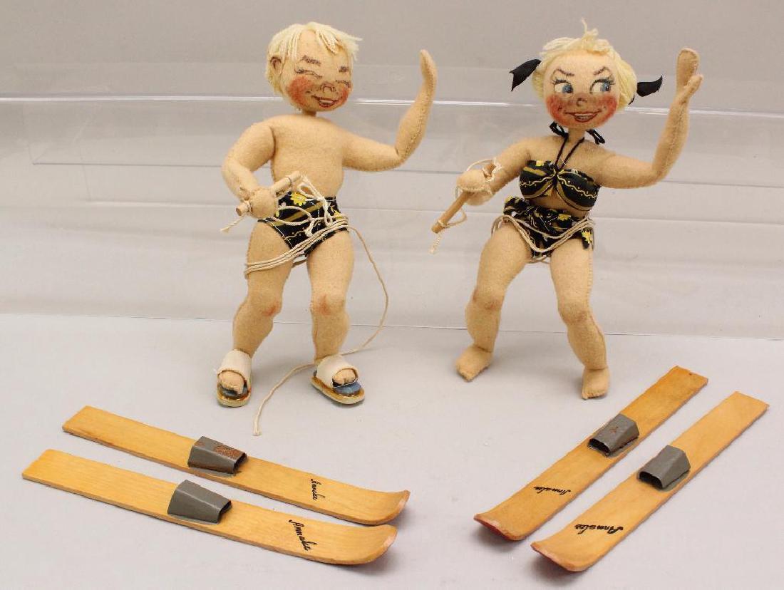 PAIR OF ALL ORIGINAL EARLY UNDATED TAGGED ANNALEE: Both have fine yellow wool hair and are dressed in matching bathing suits. Each ski has the word Annalee on it. Boy is also wearing a pair of sandals. Condition: minor moth damage. Minor age discolora