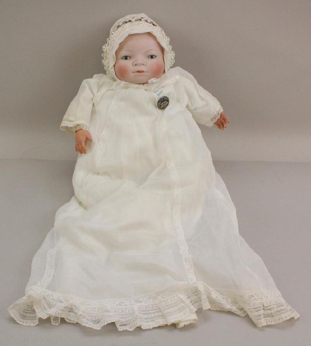 16" L 14 CIR. COPR. BY GRACE S. PUTNAM MADE IN: Blue sleep eyes, closed mouth, painted light brown hair. Cloth body (stamp illegible) with celluloid hands. Dressed in original tagged (K and K Bye-Lo Baby) white gown, petticoat. Socks. Vintage decor
