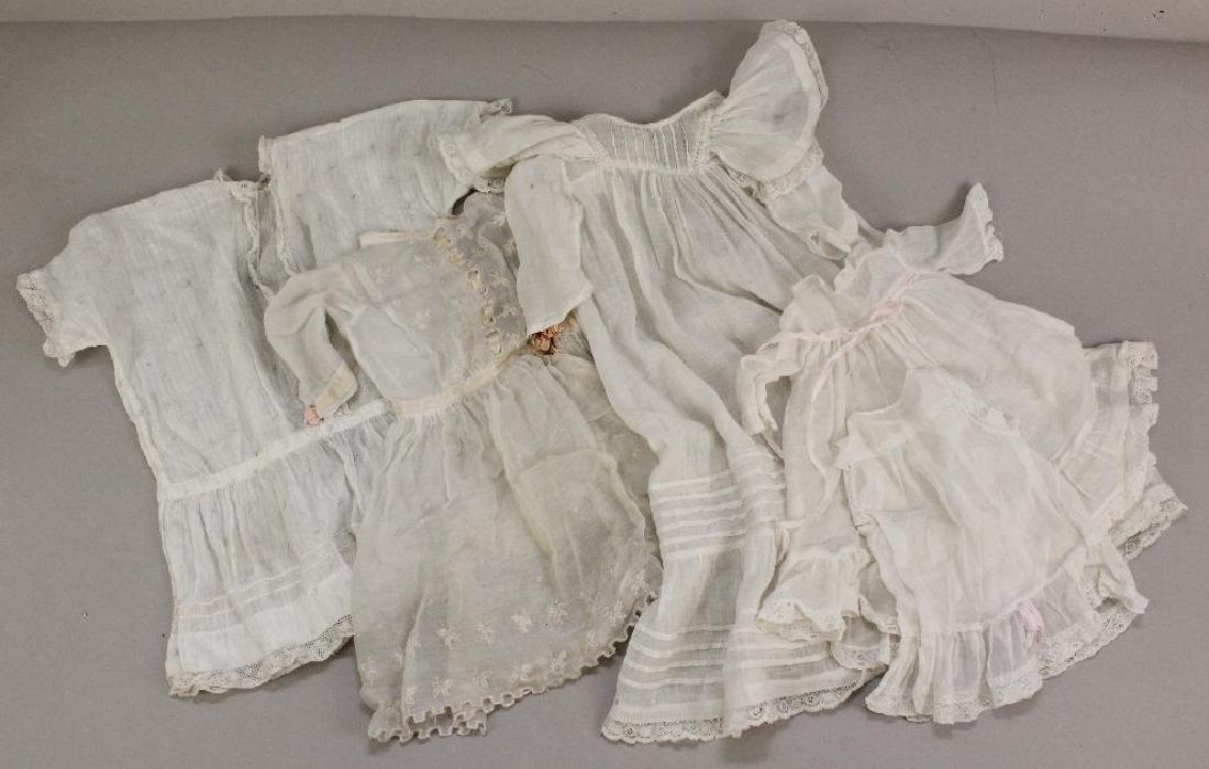 BODY PARTS/SUPPLIES: LOT OF (4) ANTIQUE WHITE COTTON: Sizes - 10" L. with matching petticoat. 14" L. 14" L. with faint print. 17 1/12" L. Baby gown. Condition: minor age loss. This lot is being sold AS IS.