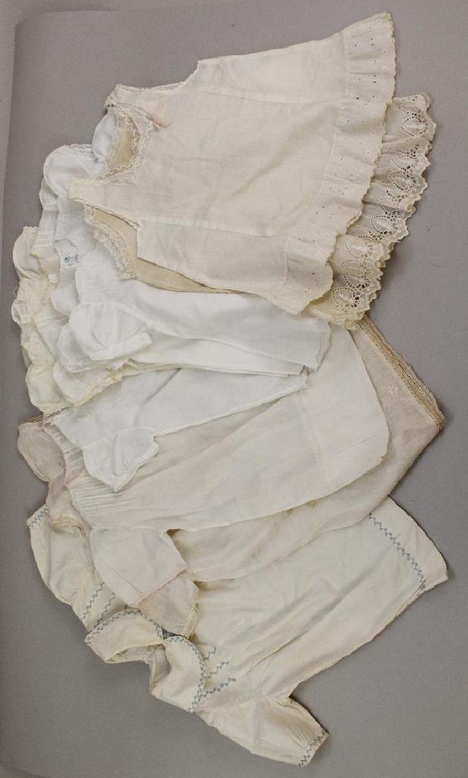 BODY PARTS/SUPPLIES: LOT OF ANTIQUE/VINTAGE WHITE: 1930's-1950's. (8) Dresses. All have some embroidery and/or mini tucking trim. (The one with blue embroidery has been repaired). (2) Slips. Condition: as stated. Minor age discoloration.