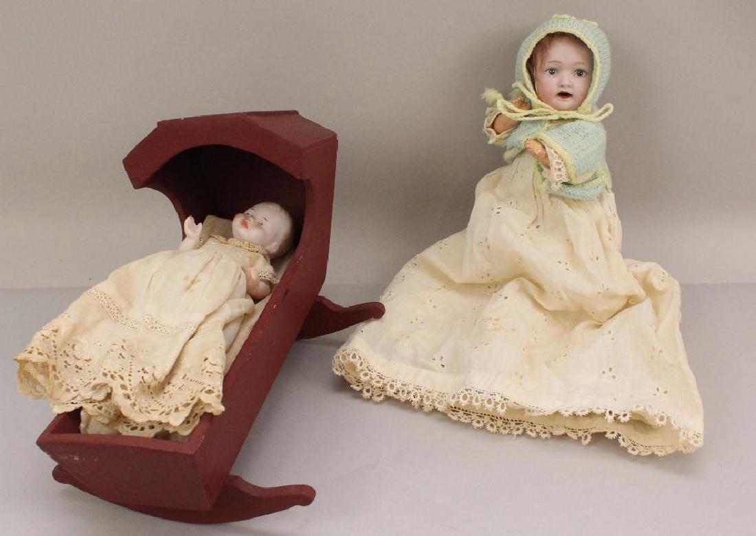 PAIR OF BISQUE HEAD BABY DOLLS: MORIMURA CHARACTER &: 8" 22 MB (in circle) Japan 3/0 with painted eyes, open mouth, brown mohair wig. 5 Pc. papier mache bent limb baby body. Dressed in vintage eyelet gown/petticoat and knit sweater, cap, booties. Conditi
