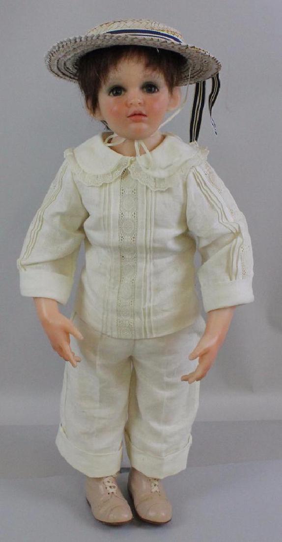24" 1997 "JORDI" DOLL, L.E. 8/20, BY ARTISTS JUANITA &: Resin head with sationary glass eyes, human hair wig. Resin shoulder plate, lower arms and legs with molded boots on cloth body. Doll is signed on stomach. Dressed in 2 pc. white linen outfit with tri