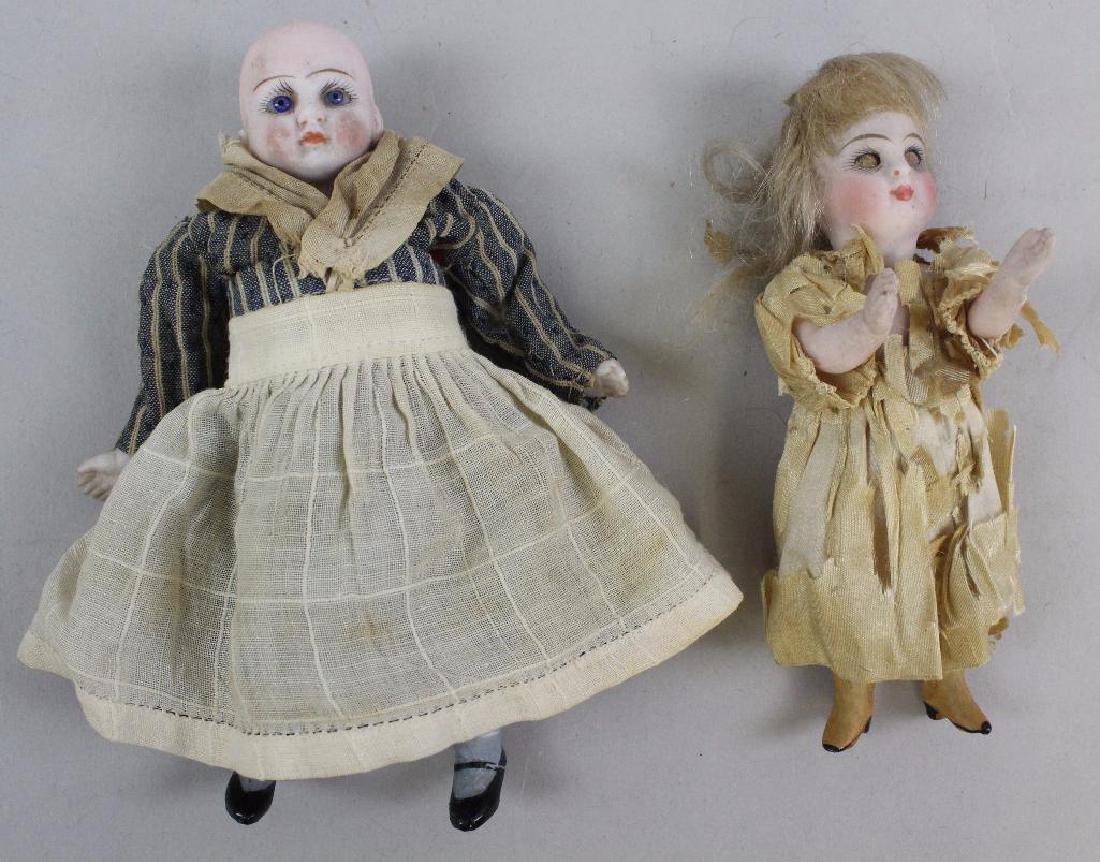 PAIR OF GERMAN ALL BISQUE DOLLS WITH GLASS EYES. (1 of 3)