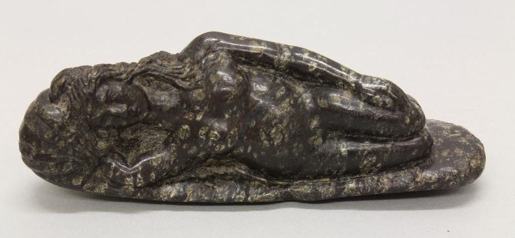Roman Stone Sculpture of Woman: Reclining nude woman with head on shell in black granite. Sculpture measures 5.5" x 2.5" x 1.75" and dates from the late Roman Imperial period (300-400AD).