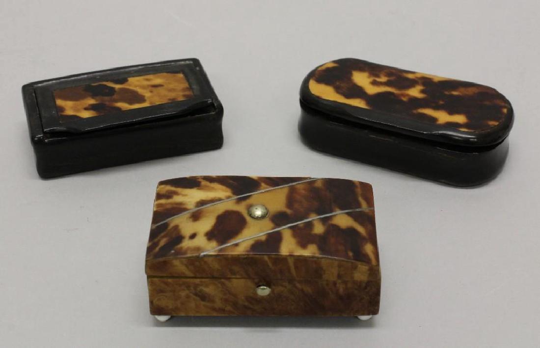 Lot of 3 Snuff Boxes: Group of three, 18th century, black lacquered snuff boxes, each with applied decoration and sliver or brass details. Paper mache snuff box Marked "ED Huckine Wa" carved into the undersi