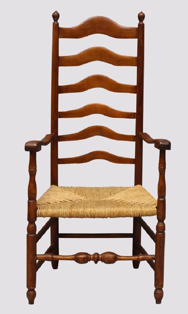 Delaware Valley Ladder Back Armchair: Cherry with six arched graduated splats, rush seat, ball and wafer turned stretcher on turned legs, 48"h x 23"w x 16.5"d.