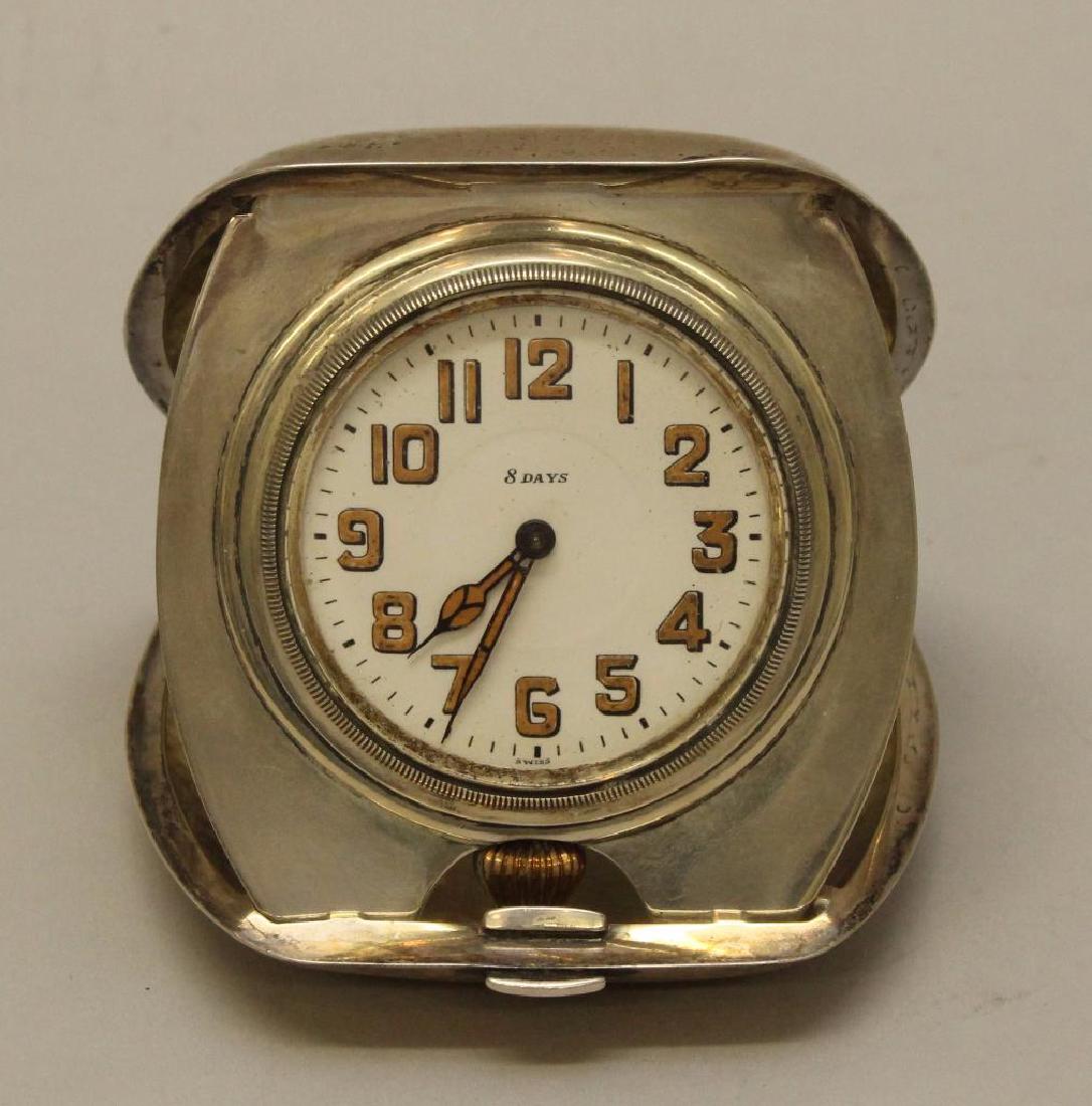 Tiffany and Co. Watch: Tiffany and Co, sterling silver desk watch with 8 day movement. "MEL" monogrammed on top. 3.5"h x 3" w. Overall weight 6.47 troy oz.