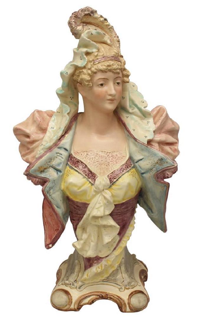 Faience Bust of Woman: Colorfully glazed bust of woman. Marked "BU 1615" at lower reverse of piece. 17"h x 9.5"w x 6.75"d