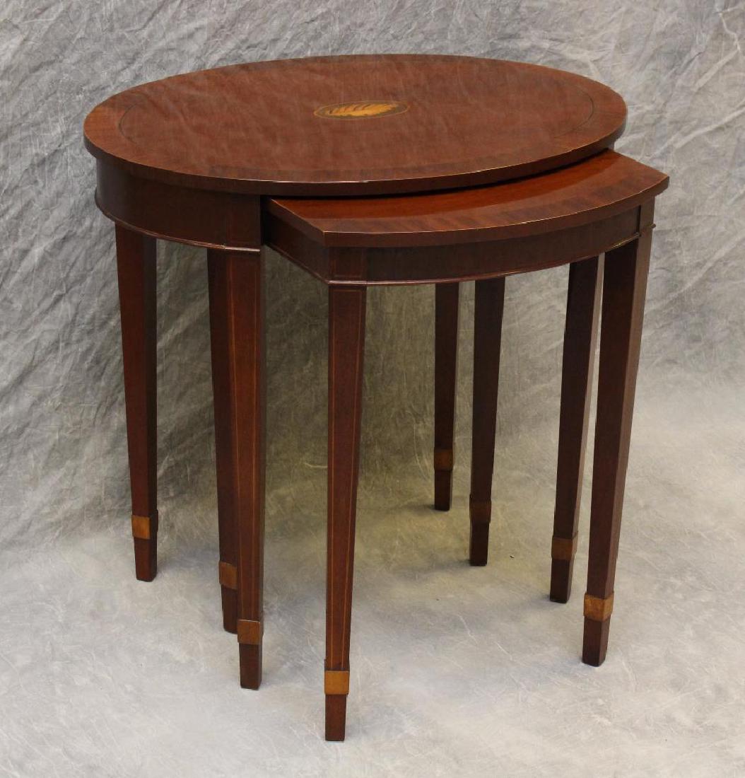 Set of (2) Baker Nesting Tables: Mahogany with a shell inlay top with banded inlay tapered legs, approx. 25"h x 26"w x 17"d.