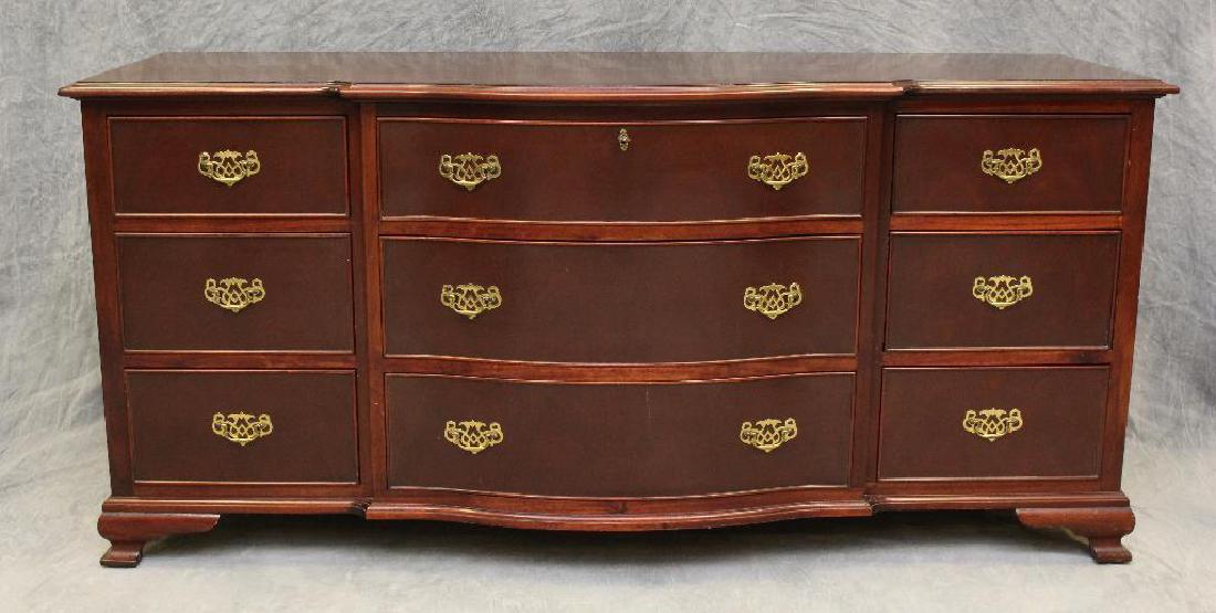 Mahogany Serpentine Front Dresser: Oyster veneered top with three sets of three graduated drawers on ogee feet, 34.5"h x 72"w x 25"d.