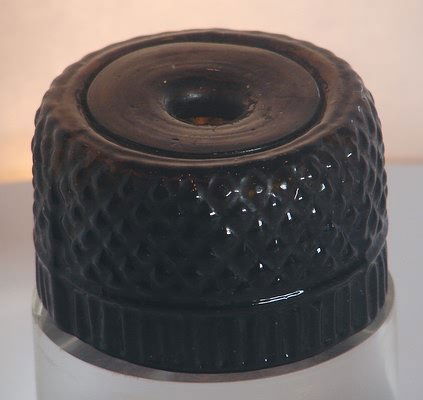 Dark Amber Blown Three Mold Geometric Ink.: Three piece mold, hand blown ink in dark amber olive with geometric design on outer body. Base has open pontil mark. 1 1/2" tall, 2 3/8" diameter. No noted damages.