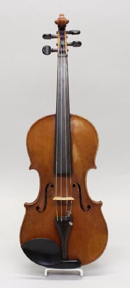 Wilmer E. Comstock Violin: Labeled "Wilmer E. Comstock, Boston, Mass, 1920." Two-piece back.