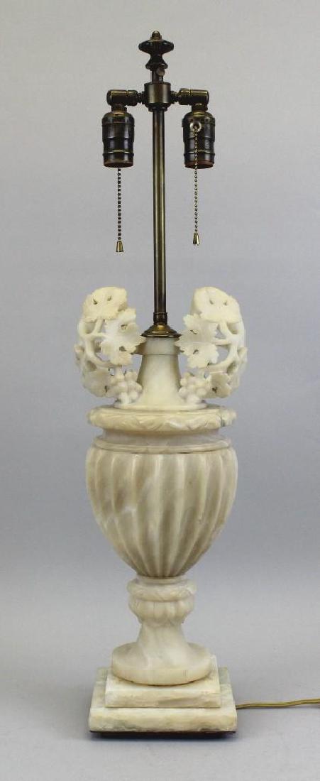 Alabaster Lamp: Carved alabaster urn shaped lamp, cutout details of carved grapes and leaves. lamp 29.5 -33.5"h x 7.5"w, shade 12"h x 18.25"w