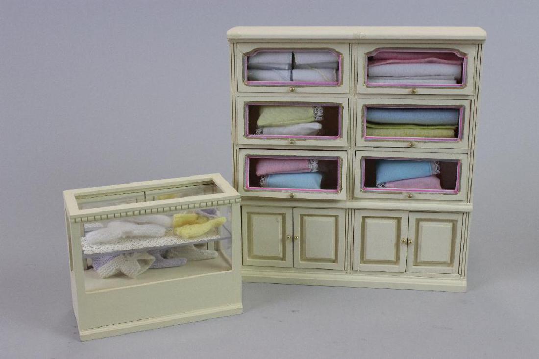 Tall display case and Display case, knitted baby items (1 of 4)