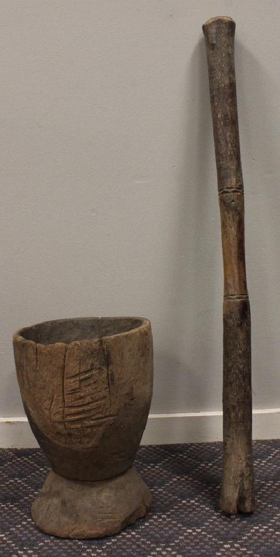 Mortar & Pestle: 20th Century. Mortar & Pestle. Carved Wood. Mortar is 16" long. Pestle is 44" tall. 