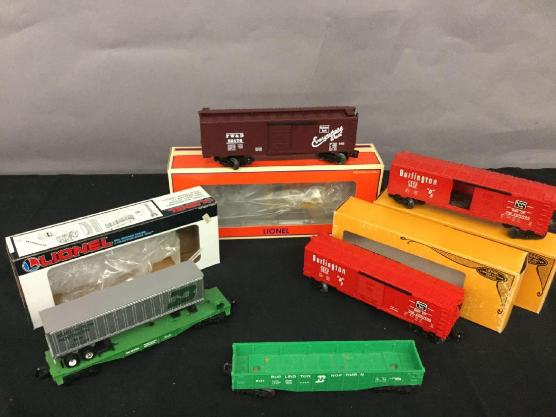 Grouping of five Lionel Trains: Burlington Northern flat car with trailer 6-16308, (2) Burlington boxcar 6-9436, Burlington gondola 9141 not in original box, Burlington boxcar 6-52176