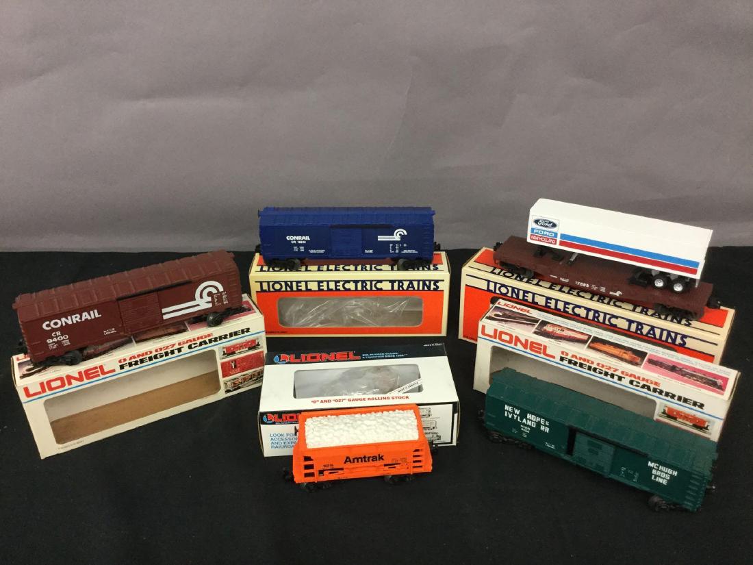 Grouping of five Lionel Trains: Amtrak ore car 6-19315, Newhope and Ivy land boxcar 6-9454, Conrail boxcar 6-9400, Conrail boxcar 6-16248, LCCA convention car 6-17888.