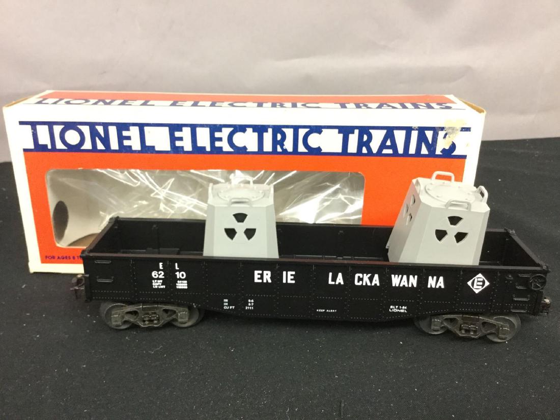 Grouping of five Lionel Trains: D L & W Phoebe Snow 9411, Erie operating hopper 6-6117, Delaware Lackawanna and Western Standard "O" caboose 6-17604, Burlington boxcar 6-52178, Erie Lackawanna gondola 6210.