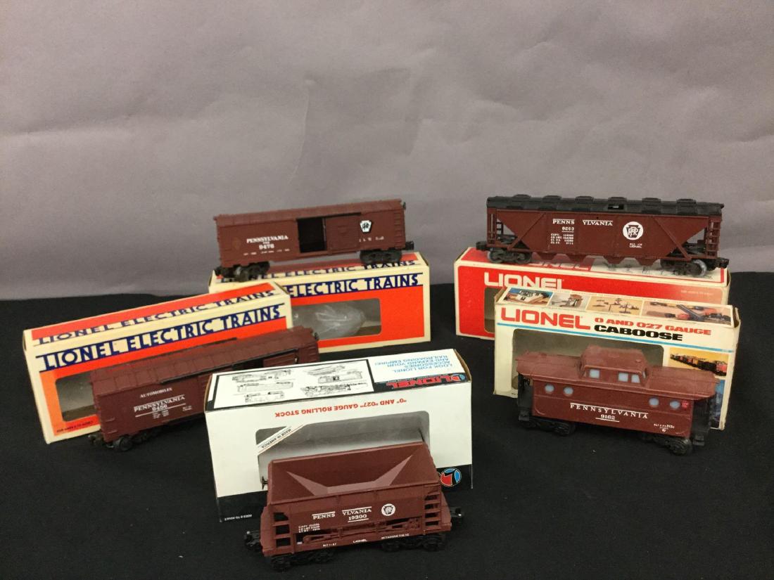 Grouping of five Lionel Trains: Pennsylvania or car 6-19300, Pennsylvania single door box car 6-9476, Pennsylvania door double door boxcar 6-9456, PA covered hopper 9262, not in original box, PA caboose 9162, not in original box.