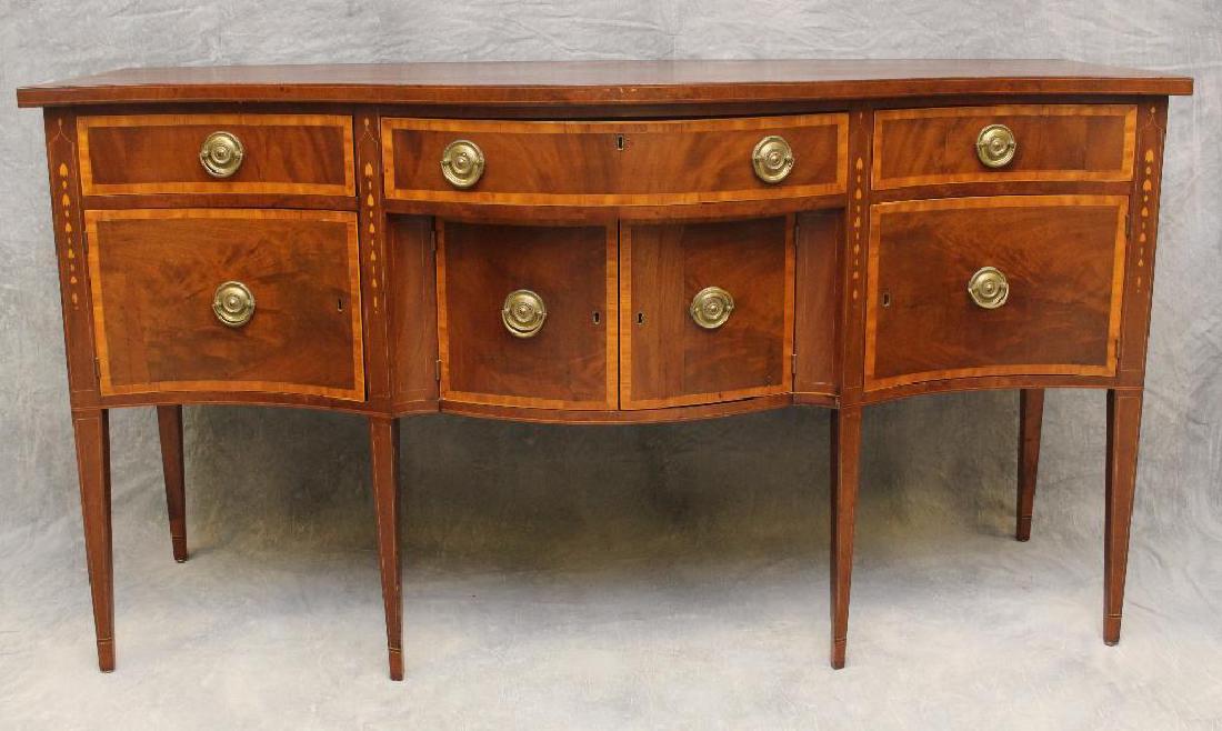 Hepplewhite Sideboard: Mahogany with cross banded and bell flower inlay, three drawers over four doors on tapered legs, 40"h x 74"w x 29"d.