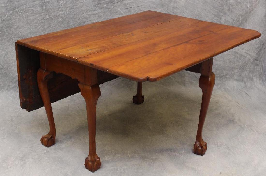 Chippendale Walnut Drop-Leaf Table: Scrolled apron with cabriole legs and ball and claw feet, 28"h x 53"w x 46.5"d.