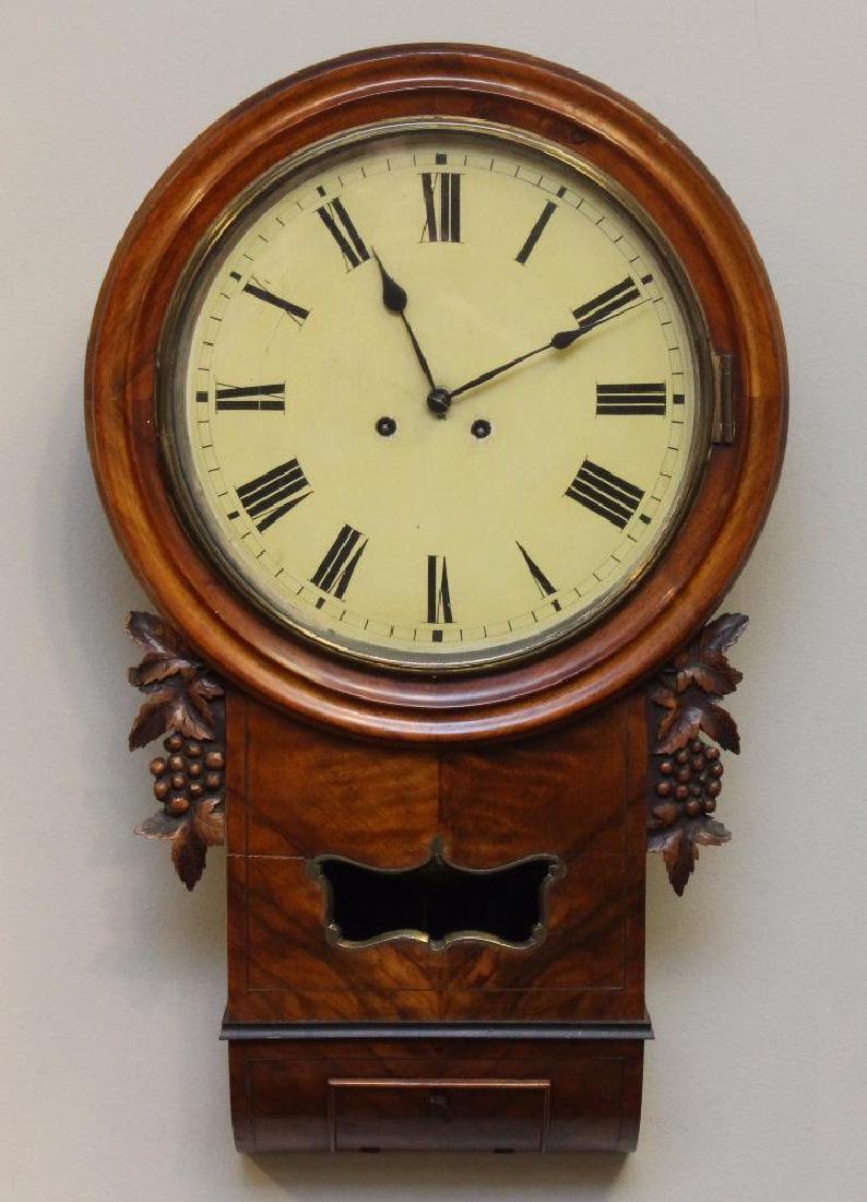 German Wall Clock: Walnut case with fruit carved friezes, 8 day works and fusee movement. Provenace on inside, Late 19th Century, 27"h x 16.5"w x 5"d.