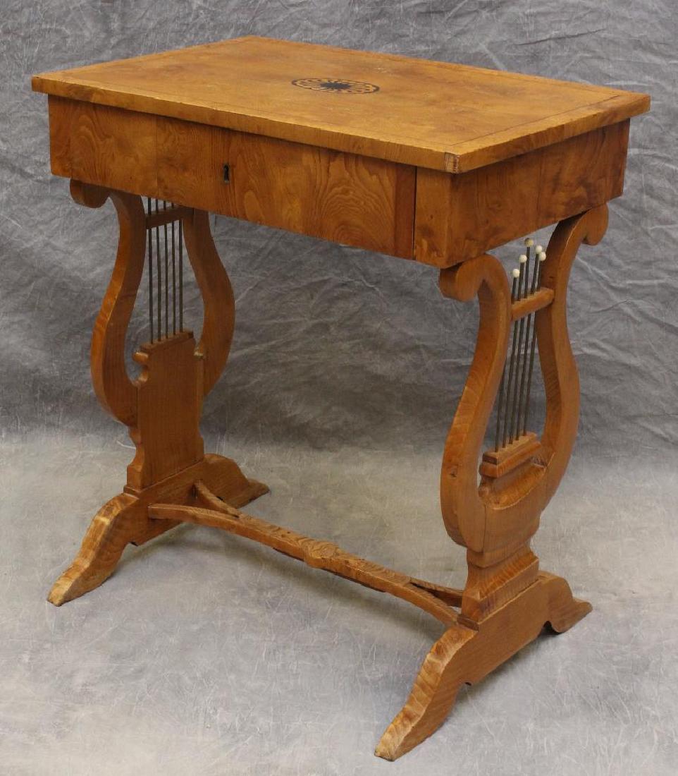 Biedermeier Elm and Burl Elm Work Table: Floral marquetry center top motif, one drawer, lyre pillars conforming to downswept legs on a trestle base, 30"h x 26"w x 16.5"d.
