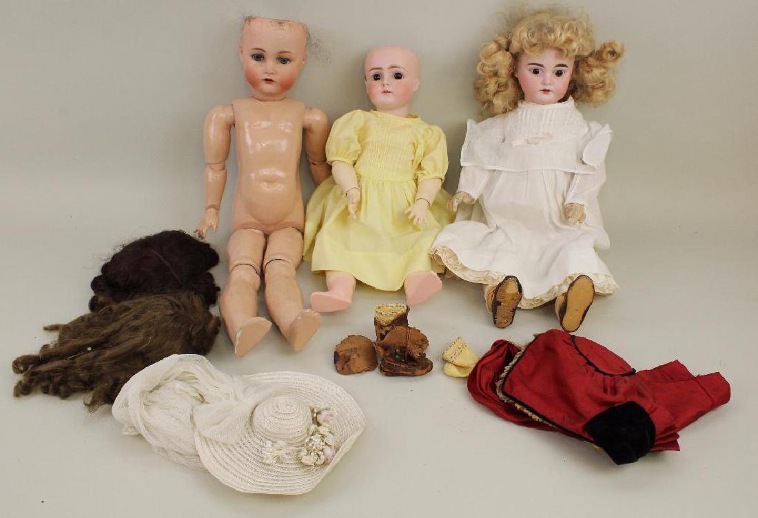 LOT OF BODY PARTS/SUPPLIES: (3) ANTIQUE BISQUE SOCKET: All of these dolls have replaced vintage wigs, open mouths, papier mache ball jointed bodies. Doll 1 -18" "12" , sleep eyes. Newer clothing, antique boots. Condition: head has been repaired. Doll 2 -