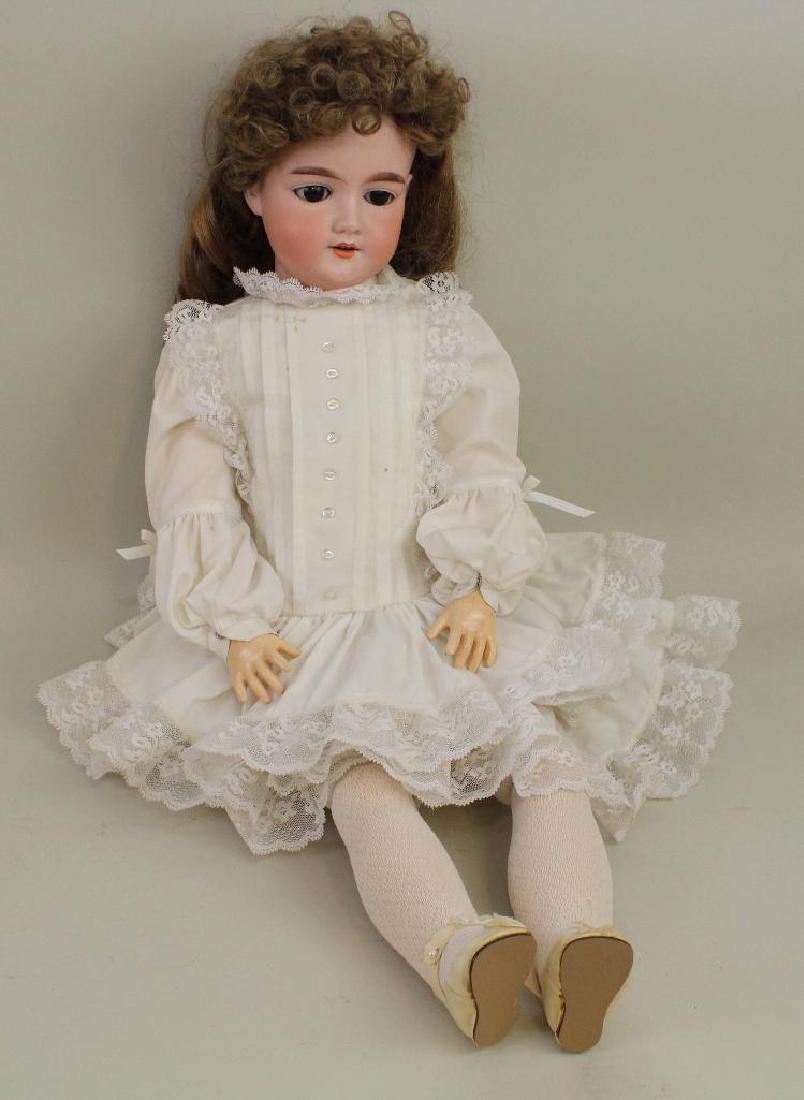 28" MADE IN GERMANY 390. A.11.M. ANTIQUE BISQUE HEAD: Brown sleep eyes, open mouth, replaced wig. Papier mache ball jointed body. Dressed in newer reproduction clothing, shoes, socks. Condition: mold imperfection under right ear otherwise nothing observe