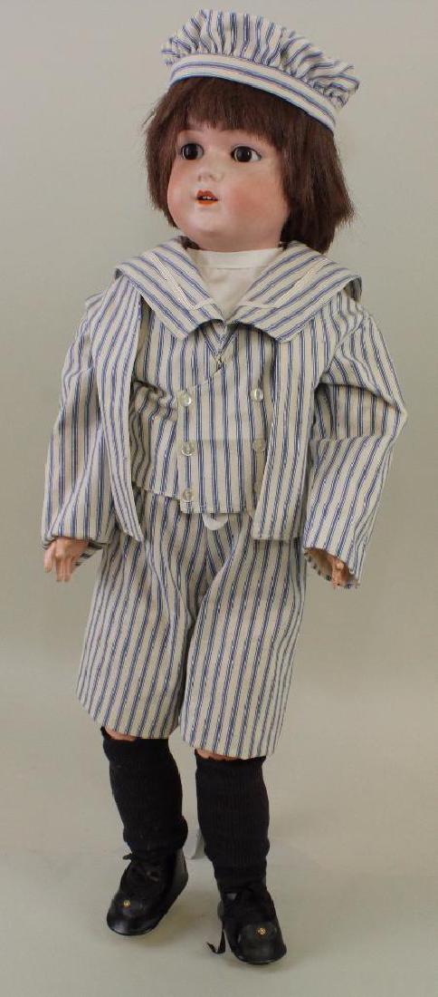 24" WALLY 7. L 7 72 LIMBACH MADE IN GERMANY ANTIQUE: Brown sleep eyes, open mouth, synthetic wig. Papier mache ball jointed body. Dressed as a boy in a reproduction 4 pc. sailor suit. Oilcloth shoes, socks. Stand. Condition: bisque is rough but nothing
