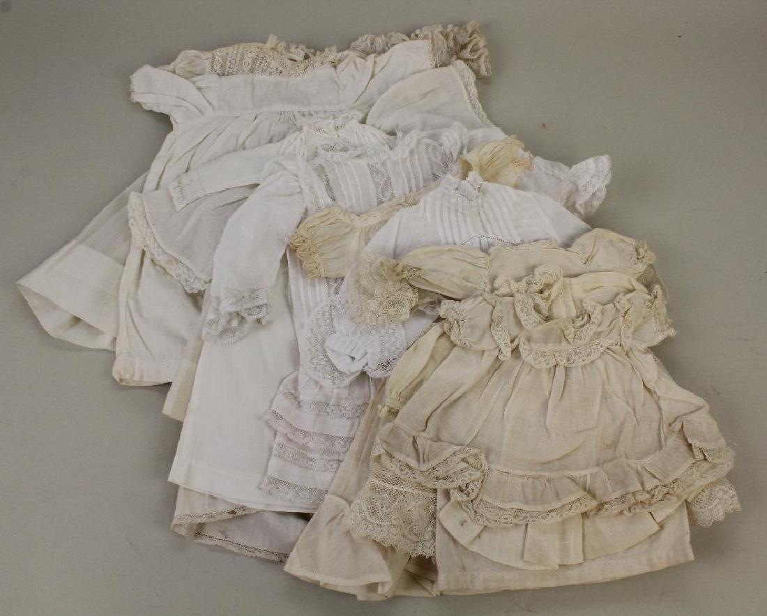DOLL PARTS & SUPPLIES: LOT OF ANTIQUE DOLL DRESSES. (1 of 4)