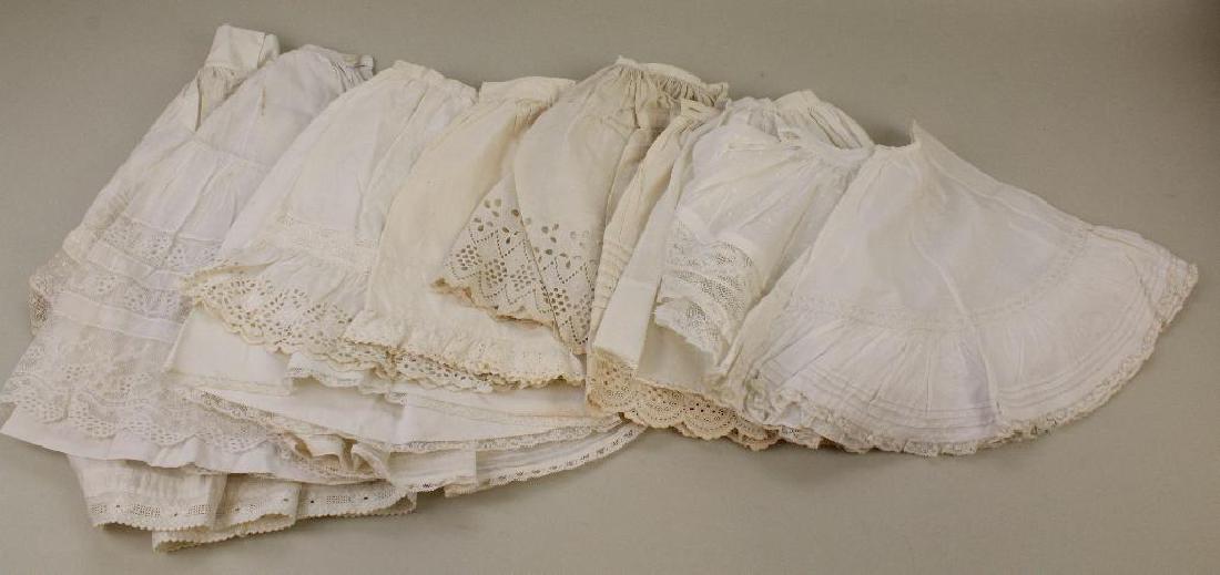 BODY PARTS & SUPPLIES: LOT OF ANTIQUE DOLL PETTICOATS.: (13) White cotton petticoats. 9" - 19". Condition: minor age discoloration.