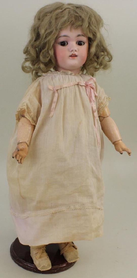 19" MADE IN GERMANY D. 1/2.168.8 1/2 ANTIQUE BISQUE: Stationary brown eyes, open mouth, original full curly tosca mohair wig, plaster pate. Papier mache ball jointed body. Dressed in antique cotton dress, petticoat. Oilcloth shoes, socks. Newer panties.