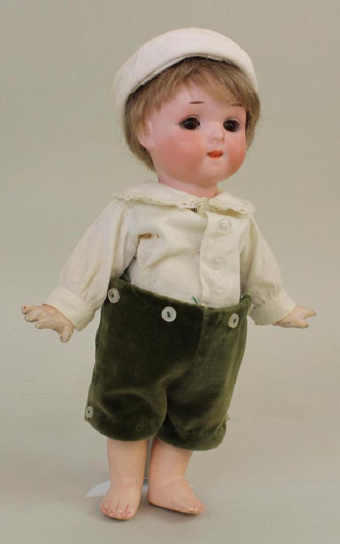 8 1/2" 200 A.6/0.M. GERMANY D.R.G.M. 243./1. ANTIQUE: Brown sleep eyes, closed mouth with tip of tongue showing, brown mohair wig. 5 Pc. papier mache toddler body. Dressed in newer white shirt, velveteen knee length pants. Vintage sailor hat. No shoes, s